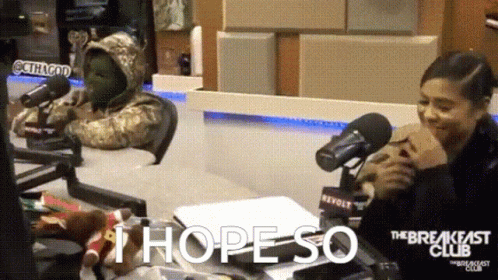 A Woman Sitting In Front Of A Microphone With The Words " I Hope So " Written On It GIF