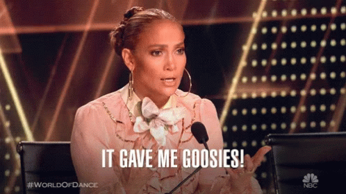 A Woman Sitting In Front Of A Microphone With The Words It Gave Me Goosies GIF