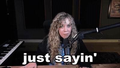 A Woman Sitting In Front Of A Microphone With The Words Just Sayin ' Below Her GIF