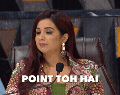 A Woman Sitting In Front Of A Microphone With The Words Point Toh Hai Written On The Screen Behind Her GIF