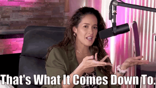 A Woman Sitting In Front Of A Microphone With The Words That 'S What It Comes Down To Below Her GIF