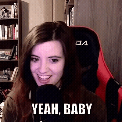 A Woman Sitting In Front Of A Microphone With The Words Yeah Baby On Her Face GIF