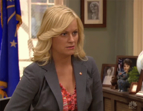 A Woman Sitting In Front Of A Nbc Logo GIF
