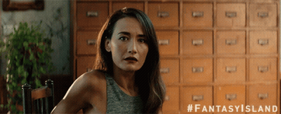 A Woman Sitting In Front Of A Row Of Drawers With The Hashtag Fantasy Island GIF