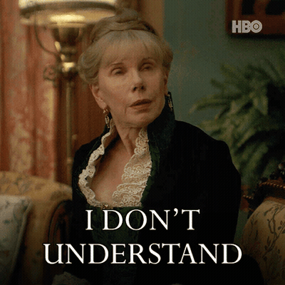 A Woman Sitting In Front Of A Sign That Says I Don 'T Understand On It GIF