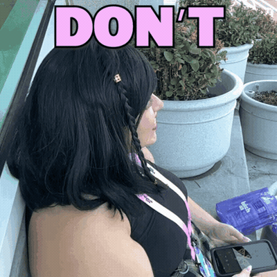 A Woman Sitting In Front Of Potted Plants With The Words " Do N't " Above Her Head GIF