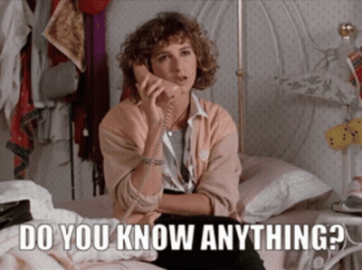 A Woman Sitting On A Bed Talking On A Phone With The Words Do You Know Anything Written Below Her GIF