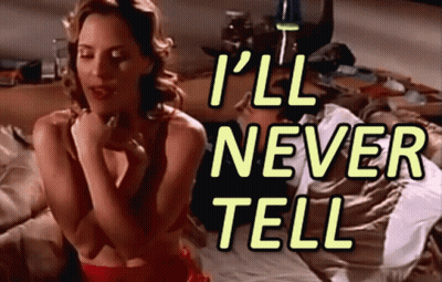 A Woman Sitting On A Bed With The Words " I 'Ll Never Tell " GIF