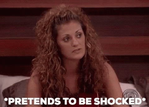 A Woman Sitting On A Bed With The Words Pretends To Be Shocked GIF