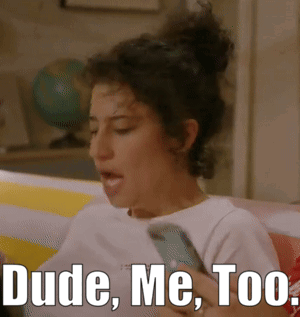 A Woman Sitting On A Couch Holding A Cell Phone With The Words Dude Me Too Written Below Her GIF