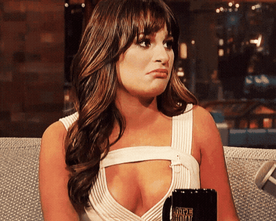 A Woman Sitting On A Couch Holding A Coffee Mug That Says Caffeine Free GIF