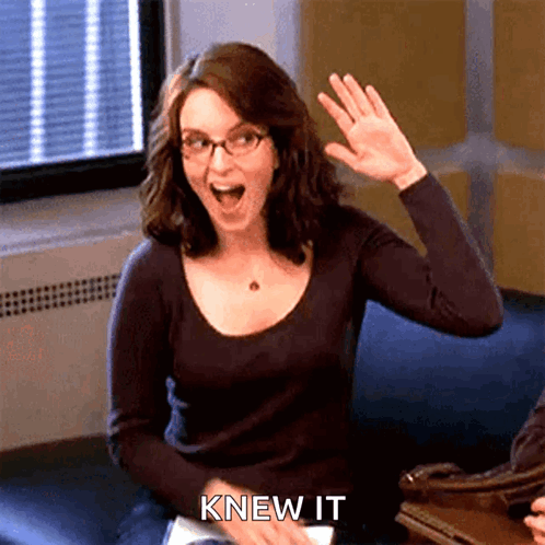 A Woman Sitting On A Couch Waving Her Hand With The Words " Knew It " Above Her GIF