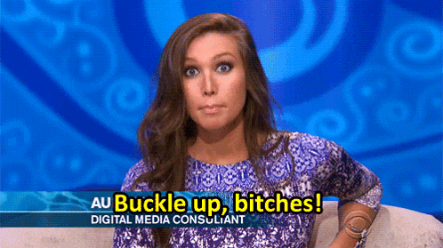 A Woman Sitting On A Couch With A Sign That Says Au Buckle Up Bitches Digital Media Consultant GIF