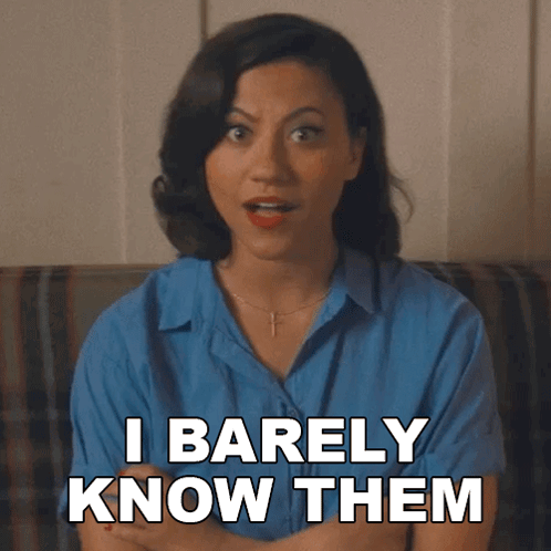 A Woman Sitting On A Couch With Her Arms Crossed Says I Barely Know Them GIF