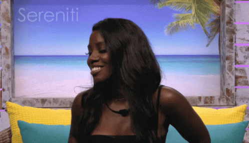 A Woman Sitting On A Couch With Sereniti Written In The Background GIF