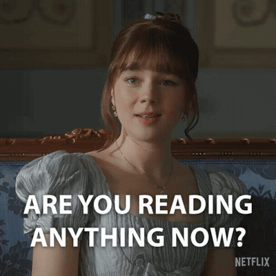 A Woman Sitting On A Couch With The Words " Are You Reading Anything Now " On The Bottom GIF