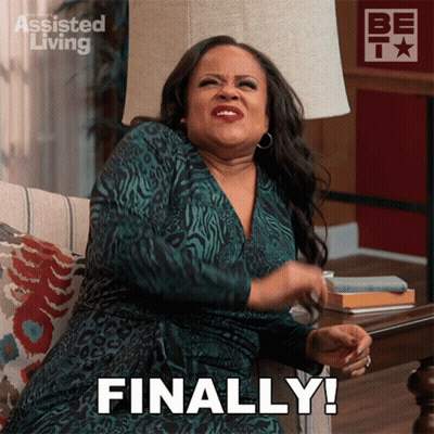 A Woman Sitting On A Couch With The Words Finally Written On Her Face GIF