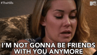 A Woman Sitting On A Couch With The Words I 'M Not Gonna Be Friends With You Anymore GIF