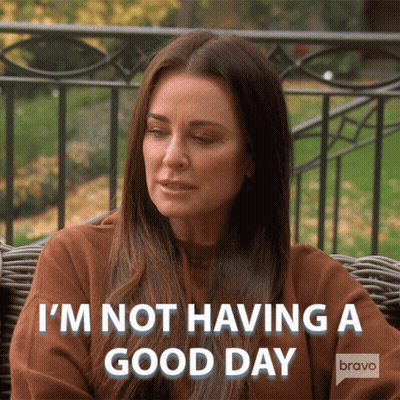 A Woman Sitting On A Couch With The Words " I 'M Not Having A Good Day " Behind Her GIF