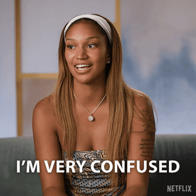 A Woman Sitting On A Couch With The Words I 'M Very Confused GIF
