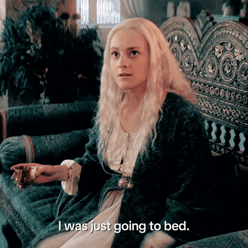 A Woman Sitting On A Couch With The Words I Was Just Going To Bed GIF