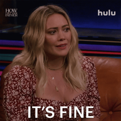 A Woman Sitting On A Couch With The Words " It 'S Fine " On Her Face GIF