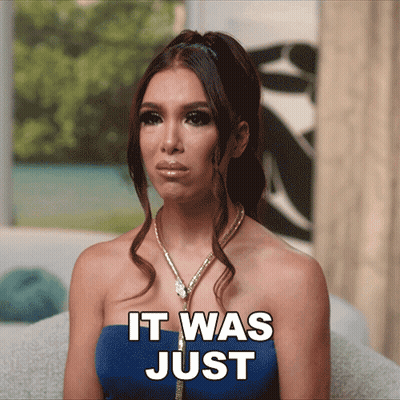 A Woman Sitting On A Couch With The Words " It Was Just " On Her Face GIF