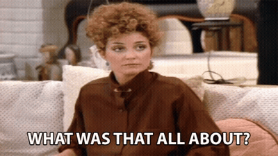 A Woman Sitting On A Couch With The Words What Was That All About GIF