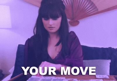 A Woman Sitting On A Couch With The Words " Your Move " On The Bottom Right GIF