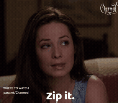A Woman Sitting On A Couch With The Words Zip It On Her Chest GIF