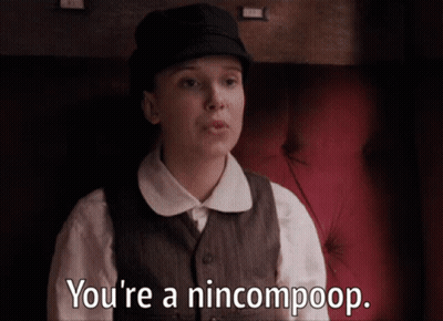 A Woman Sitting On A Red Couch Says You 'Re A Nincompoop GIF