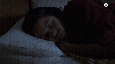 A Woman Sleeping In A Bed With A Facebook Logo On The Bottom GIF