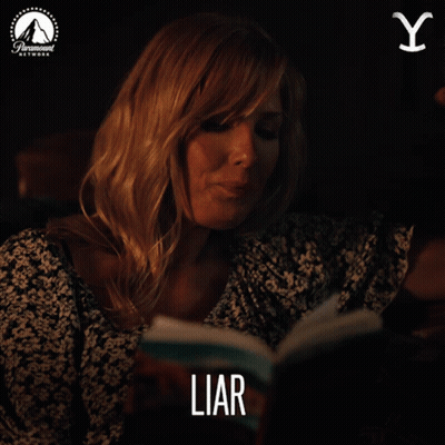 A Woman Smoking A Cigarette While Reading A Book Titled Liar GIF