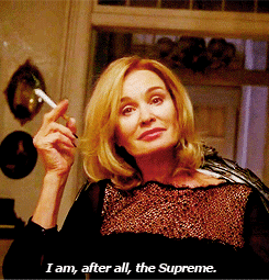 A Woman Smoking A Cigarette With The Words I Am After All The Supreme Below Her GIF