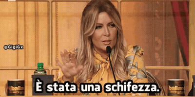 A Woman Speaking Into A Microphone With The Words E Stata Una Schiezza GIF