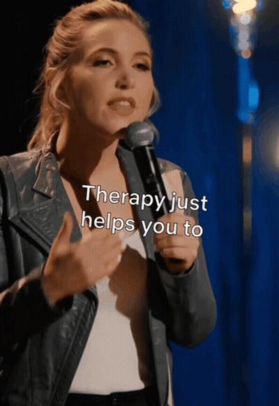 A Woman Speaking Into A Microphone With The Words " Therapy Just Helps You To " Above Her GIF