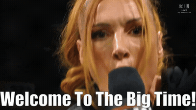 A Woman Speaking Into A Microphone With The Words Welcome To The Big Time Written Below Her GIF