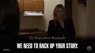 A Woman Standing In A Kitchen With The Words We Need To Back Up Your Story On The Bottom GIF