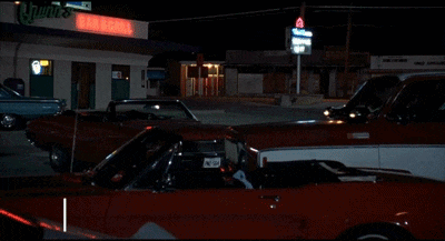 A Woman Standing In A Parking Lot With The Words Alright Alright Alright On The Screen GIF