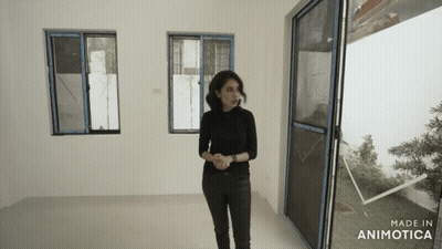 A Woman Standing In A Room With The Words Made In Animatica On The Bottom GIF