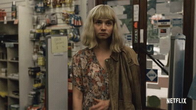 A Woman Standing In A Store With A Netflix Logo On The Bottom Right GIF