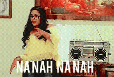A Woman Standing In Front Of A Boombox That Says Nanah Nanah On It GIF