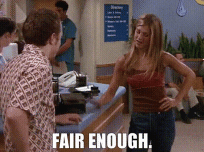 A Woman Standing In Front Of A Counter With The Words Fair Enough Written On The Bottom GIF