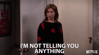 A Woman Standing In Front Of A Door That Says I 'M Not Telling You Anything By Netflix GIF