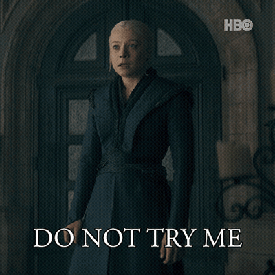 A Woman Standing In Front Of A Door With The Words Do Not Try Me On The Bottom GIF