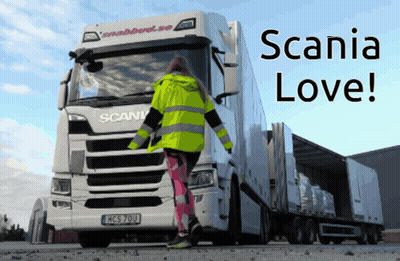 A Woman Standing In Front Of A Scania Truck That Says Scania Love GIF