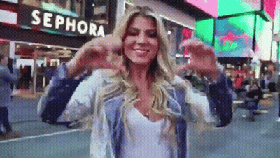A Woman Standing In Front Of A Sephora Sign GIF