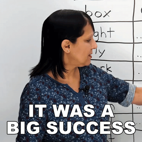 A Woman Standing In Front Of A White Board With The Words It Was A Big Success GIF