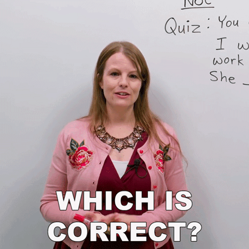 A Woman Standing In Front Of A White Board With The Words " Which Is Correct " Written On It GIF