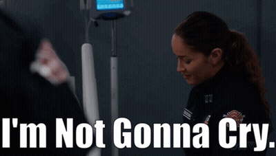 A Woman Standing In Front Of An Iv Machine With The Words I 'M Not Gonna Cry Written Above Her GIF